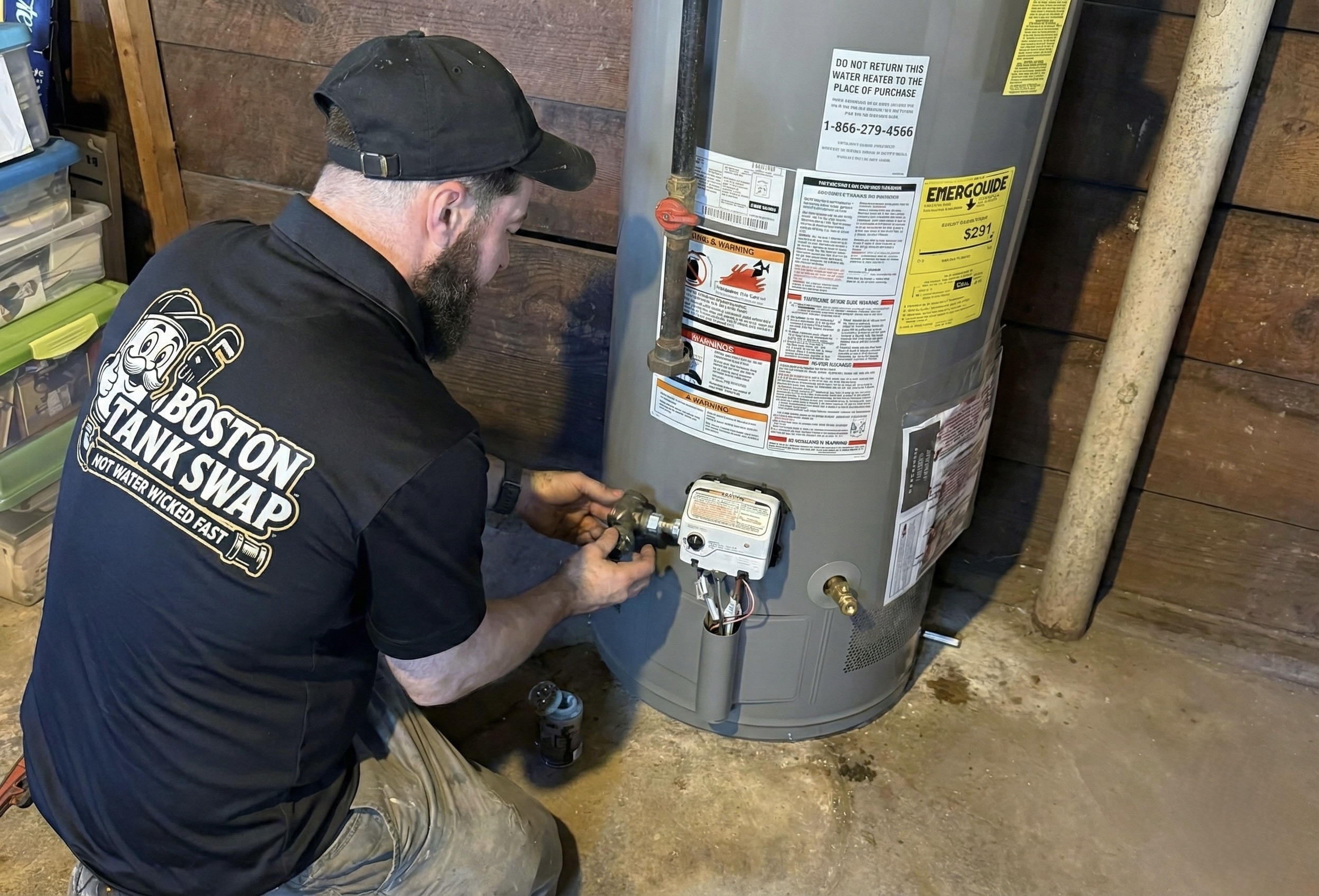 Technician checking a residential water heater in a utility space.