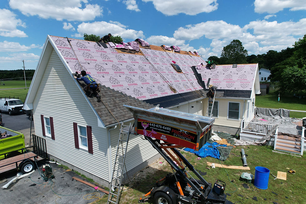 Roofing crew installing a complete shingle roof assembly on a home.