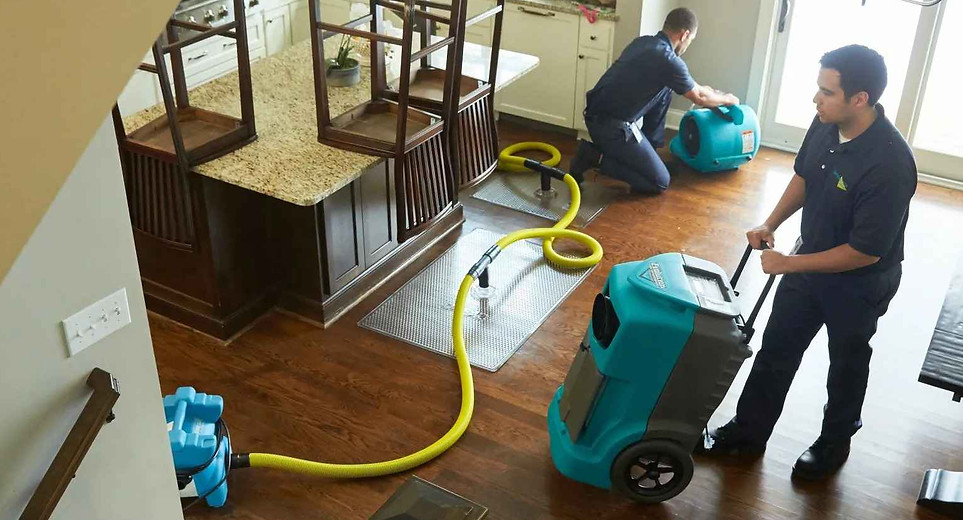 Extraction equipment being used on a kitchen floor after an indoor water release.